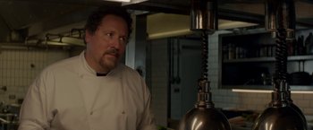 Movie still from “Chef” (2014), directed by Jon Favreau – A man standing in a kitchen next to an oven; Close Up shot, Low angle
