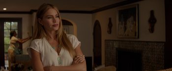 Movie still from “Chef” (2014), directed by Jon Favreau – A beautiful blonde woman standing in a living room; Close Up shot, Over the shoulder angle