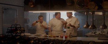 Movie still from “Chef” (2014), directed by Jon Favreau – A group of men in a kitchen preparing food; Medium shot, Low angle