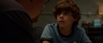 Movie still from “Chef” (2014), directed by Jon Favreau – A young boy looking at a man in a blue shirt; Close Up shot, Over the shoulder angle