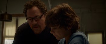 Movie still from “Chef” (2014), directed by Jon Favreau – A man and a young boy sitting next to each other; Close Up shot, Over the shoulder angle