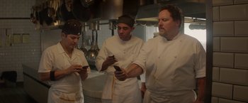 Movie still from “Chef” (2014), directed by Jon Favreau – A group of chefs looking at their cell phones in a kitchen; Medium shot, Low angle