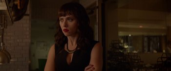 Movie still from “Chef” (2014), directed by Jon Favreau – A woman in a black dress is looking at the camera; Close Up shot, Over the shoulder angle