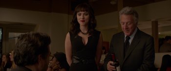 Movie still from “Chef” (2014), directed by Jon Favreau – A woman in a black dress standing next to a man; Medium shot, Over the shoulder angle