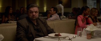 Movie still from “Chef” (2014), directed by Jon Favreau – A man sitting in front of a plate of food; Medium shot, Over the shoulder angle