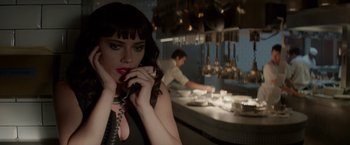 Movie still from “Chef” (2014), directed by Jon Favreau – A woman holding a phone to her ear while standing in a kitchen; Close Up shot, Low angle