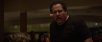 Movie still from “Chef” (2014), directed by Jon Favreau – A person with curly hair and a beard; Close Up shot, Over the shoulder angle