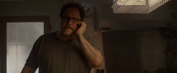 Movie still from “Chef” (2014), directed by Jon Favreau – A man with tattoos on his arms is holding a cell phone to his ear; Close Up shot, Low angle
