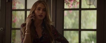 Movie still from “Chef” (2014), directed by Jon Favreau – A beautiful young woman holding a cell phone to her ear; Close Up shot, Over the shoulder angle