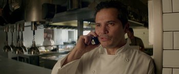 Movie still from “Chef” (2014), directed by Jon Favreau – A man wearing a chef's outfit talking on a cell phone; Close Up shot, Low angle