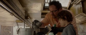 Movie still from “Chef” (2014), directed by Jon Favreau – A man wearing gloves and holding a pair of scissors; Close Up shot, Over the shoulder angle