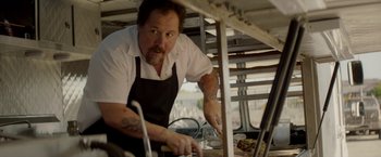 Movie still from “Chef” (2014), directed by Jon Favreau – A man in an apron preparing food on a grill; Close Up shot, Low angle