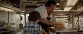 Movie still from “Chef” (2014), directed by Jon Favreau – A man and a boy preparing food in a kitchen; Medium shot, Over the shoulder angle