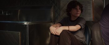 Movie still from “Chef” (2014), directed by Jon Favreau – A man sitting on the ground in a room; Medium shot, Low angle