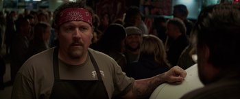 Movie still from “Chef” (2014), directed by Jon Favreau – A man with a bandana around his head; Close Up shot, Over the shoulder angle