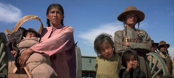 Movie still from “Cheyenne Autumn” (1964), directed by John Ford – A group of people standing next to each other on a field; Medium shot, Low angle
