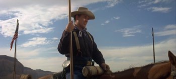 Movie still from “Cheyenne Autumn” (1964), directed by John Ford – A man in a cowboy hat riding on a horse; Medium shot, Low angle