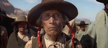 Movie still from “Cheyenne Autumn” (1964), directed by John Ford – An old man with a hat and a red necklace; Close Up shot, Low angle