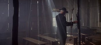 Movie still from “Cheyenne Autumn” (1964), directed by John Ford – A man in a black suit and a black hat; Wide shot, Low angle