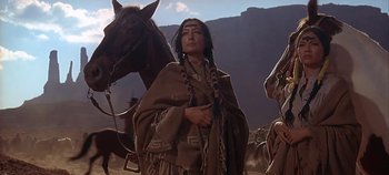 Movie still from “Cheyenne Autumn” (1964), directed by John Ford – An old native american man standing next to a horse; Medium shot, Low angle