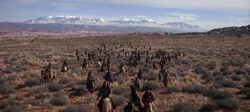 Movie still from “Cheyenne Autumn” (1964), directed by John Ford – A group of people riding horses in the desert; Extreme Wide shot, High angle