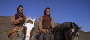 Movie still from “Cheyenne Autumn” (1964), directed by John Ford – A man sitting on top of a horse in a field; Medium shot, Low angle