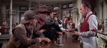 Movie still from “Cheyenne Autumn” (1964), directed by John Ford – A group of men sitting at a table with hats on; Medium shot, Low angle