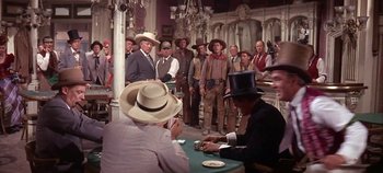 Movie still from “Cheyenne Autumn” (1964), directed by John Ford – A group of men standing around a table; Wide shot, Over the shoulder angle