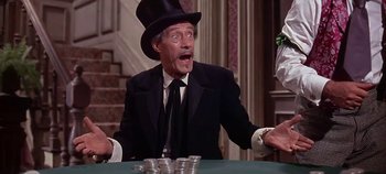 Movie still from “Cheyenne Autumn” (1964), directed by John Ford – An older man wearing a black suit and a top hat; Medium shot, Low angle