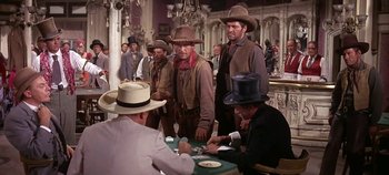 Movie still from “Cheyenne Autumn” (1964), directed by John Ford – A group of men standing next to each other in a room; Medium shot, Over the shoulder angle