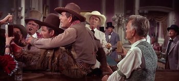 Movie still from “Cheyenne Autumn” (1964), directed by John Ford – A group of men and women wearing cowboy hats; Medium shot, Over the shoulder angle