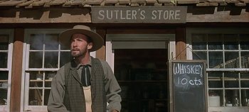 Movie still from “Cheyenne Autumn” (1964), directed by John Ford – A man standing in front of a store; Medium shot, Low angle
