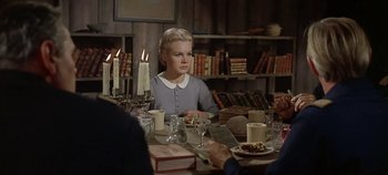 Movie still from “Cheyenne Autumn” (1964), directed by John Ford – A woman sitting at a table with a plate of food in front of her; Medium shot, Over the shoulder angle