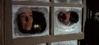 Movie still from “Cheyenne Autumn” (1964), directed by John Ford – A man and a woman looking through a window; Close Up shot, Low angle
