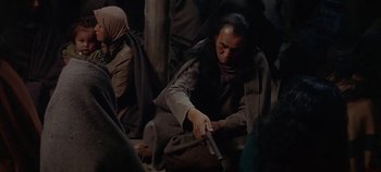Movie still from “Cheyenne Autumn” (1964), directed by John Ford – A man holding a gun while kneeling on the ground; Medium shot, High angle