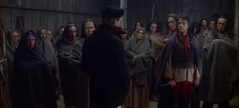 Movie still from “Cheyenne Autumn” (1964), directed by John Ford – A group of people standing in a room; Medium shot, Over the shoulder angle