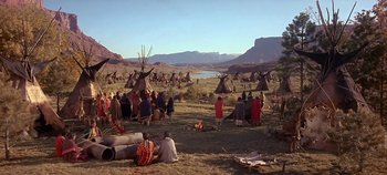 Movie still from “Cheyenne Autumn” (1964), directed by John Ford – A group of native americans gathered in a grassy field; Extreme Wide shot, High angle
