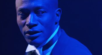 Movie still from “Chicago” (2002), directed by Rob Marshall – A person wearing a suit and tie; Close Up shot, Low angle