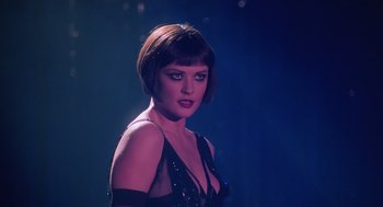 Movie still from “Chicago” (2002), directed by Rob Marshall – A woman with short hair wearing a black dress; Close Up shot, Low angle