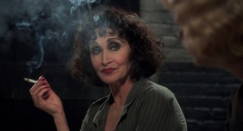 Movie still from “Chicago” (2002), directed by Rob Marshall – A person smoking a cigarette; Close Up shot, Over the shoulder angle
