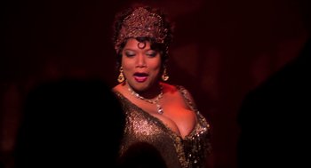 Movie still from “Chicago” (2002), directed by Rob Marshall – A woman in a gold dress and a red hat; Close Up shot, Over the shoulder angle