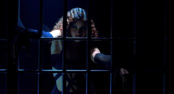 Movie still from “Chicago” (2002), directed by Rob Marshall – A woman looking through the bars of a jail cell; Medium shot, Low angle