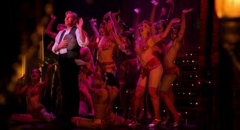 Movie still from “Chicago” (2002), directed by Rob Marshall – A group of people in costumes on a stage; Wide shot, High angle