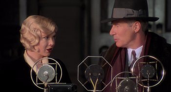 Movie still from “Chicago” (2002), directed by Rob Marshall – A man and a woman are talking to each other; Close Up shot, Over the shoulder angle