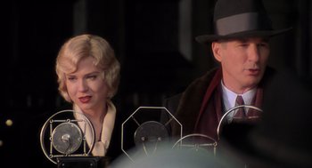 Movie still from “Chicago” (2002), directed by Rob Marshall – A man and a woman sitting next to each other; Close Up shot, Low angle