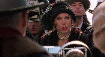 Movie still from “Chicago” (2002), directed by Rob Marshall – A woman wearing a black hat and a fur coat; Close Up shot, Over the shoulder angle
