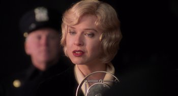 Movie still from “Chicago” (2002), directed by Rob Marshall – A woman with blonde curly hair and red lipstick; Close Up shot, Over the shoulder angle