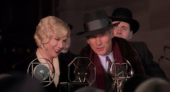Movie still from “Chicago” (2002), directed by Rob Marshall – A man and a woman are standing next to each other; Close Up shot, Low angle