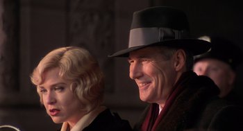 Movie still from “Chicago” (2002), directed by Rob Marshall – An older man and a younger woman sitting next to each other; Close Up shot, Low angle