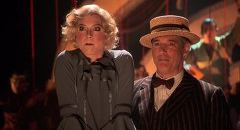 Movie still from “Chicago” (2002), directed by Rob Marshall – A man and a woman dressed in old fashion clothing; Medium shot, Low angle